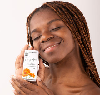 #5dayfacechallenge girl holds up a 4ml calendula and geranium facial oil.