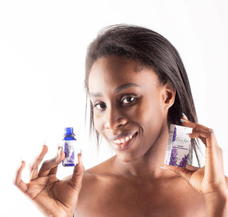 Holding the Lavender Essential Oil Blend from Flor y Amor