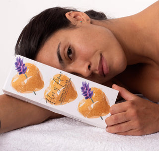 woman holding a Flor y Amor Mini Yellow Hearts - Lavender Bath Bombs - Sleep - 3 Pack (45g) with lavender, ylang ylang and lemon.