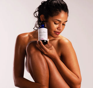 model holding Flor y Amor's Glow Body Oil with Geranium, Patchouli & Grapefruit