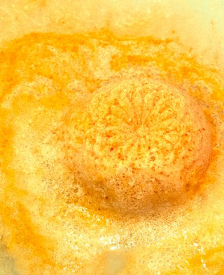 our lavender, lemon and ylang ylang Chrysanthemum Bath Bomb in use. Flor y Amor